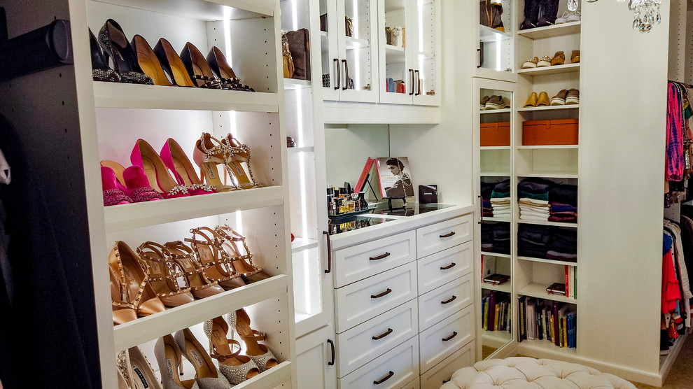 This is an example of a large classic wardrobe for women in Houston with shaker cabinets, white cabinets and carpet.