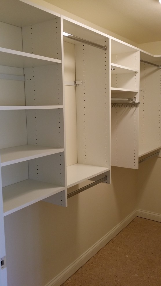 Example of a mid-sized trendy gender-neutral walk-in closet design in Milwaukee with open cabinets and white cabinets