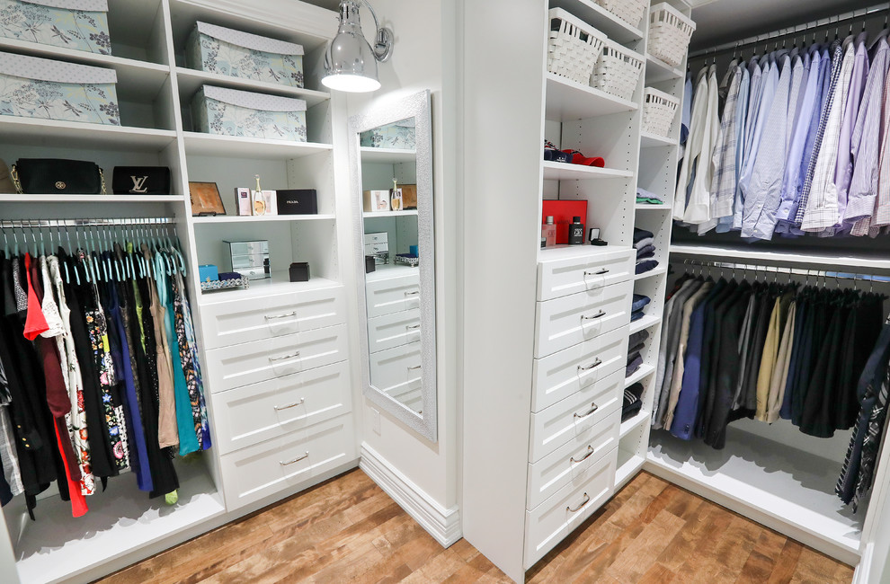 Design ideas for a large traditional gender neutral walk-in wardrobe in Montreal with open cabinets and white cabinets.