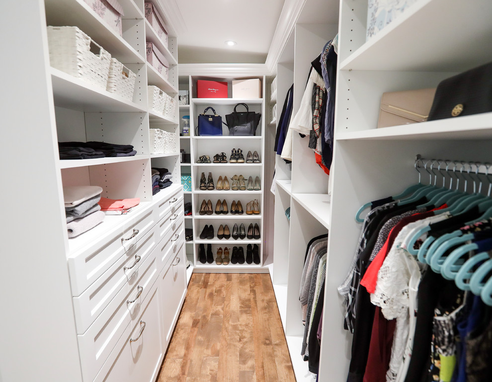 Walk-in closet - large traditional gender-neutral walk-in closet idea in Montreal with open cabinets and white cabinets
