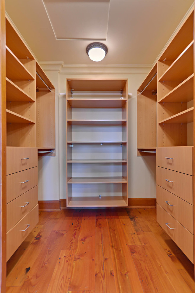 Walk-in closet - mid-sized transitional gender-neutral medium tone wood floor and brown floor walk-in closet idea in Cleveland with open cabinets and light wood cabinets