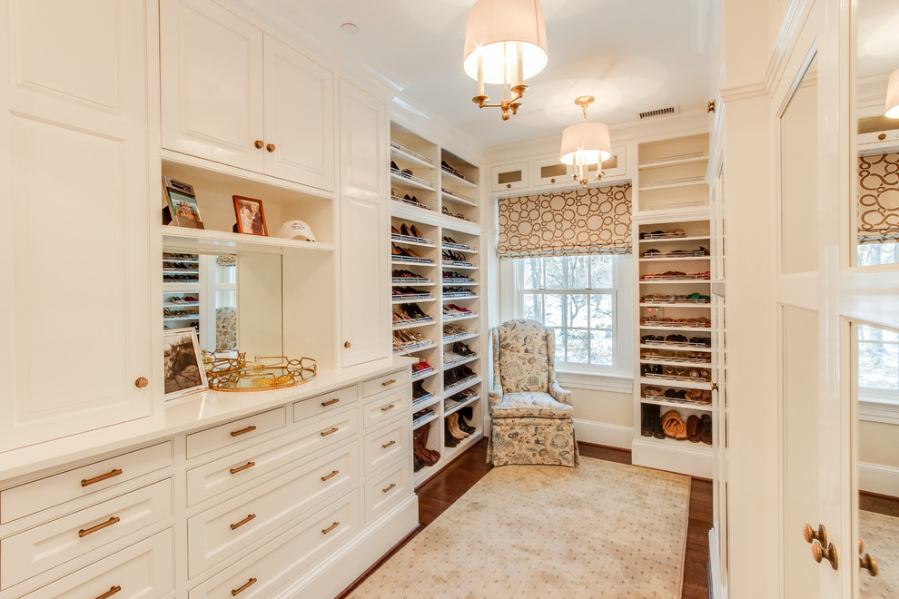 Inspiration for a traditional wardrobe for women in Other with white cabinets, dark hardwood flooring and recessed-panel cabinets.