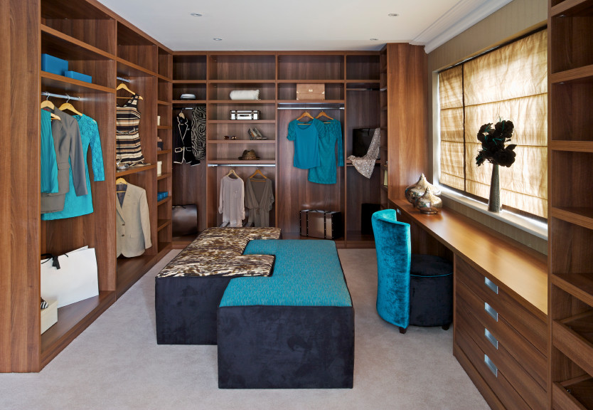 Large contemporary gender neutral dressing room in Toronto with flat-panel cabinets, medium wood cabinets and carpet.