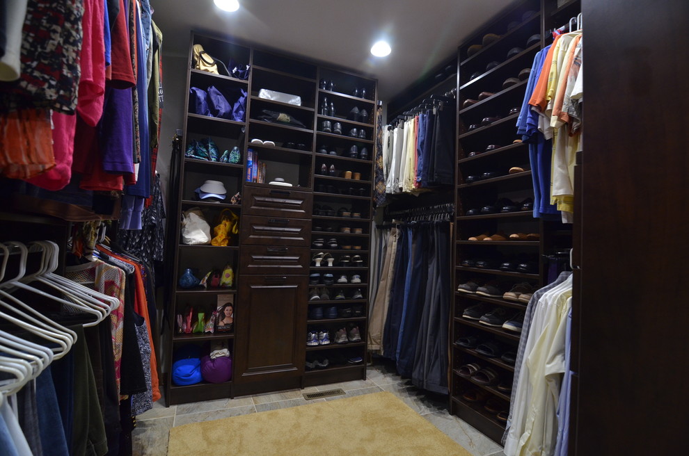 Inspiration for a medium sized traditional gender neutral walk-in wardrobe in Indianapolis with open cabinets, dark wood cabinets and limestone flooring.