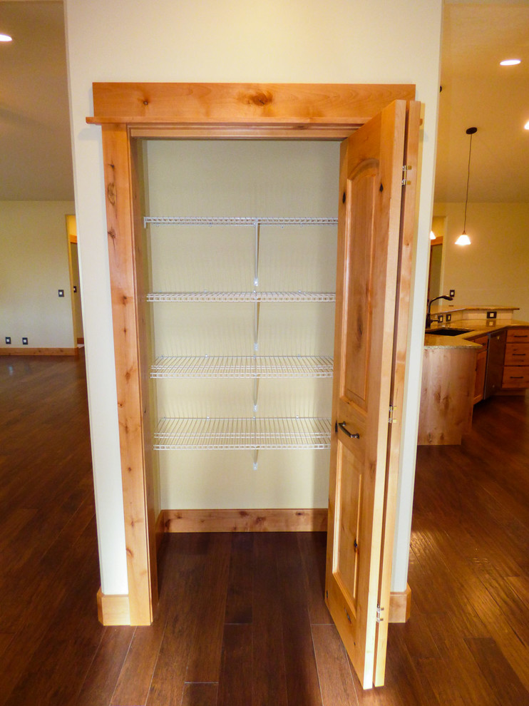 Reach-in closet - mid-sized craftsman medium tone wood floor reach-in closet idea in Other