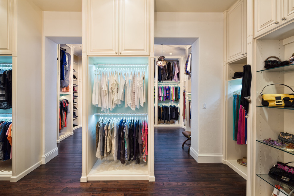 Photo of an expansive contemporary gender neutral walk-in wardrobe in Tampa with raised-panel cabinets, white cabinets and vinyl flooring.