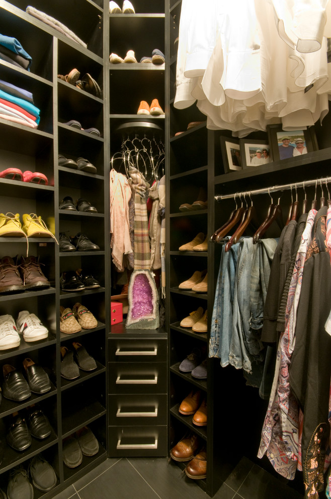 This is an example of a large contemporary walk-in wardrobe for men in Minneapolis with flat-panel cabinets and black cabinets.