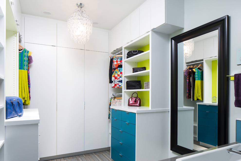 This is an example of a medium sized modern walk-in wardrobe in Raleigh with flat-panel cabinets and porcelain flooring.