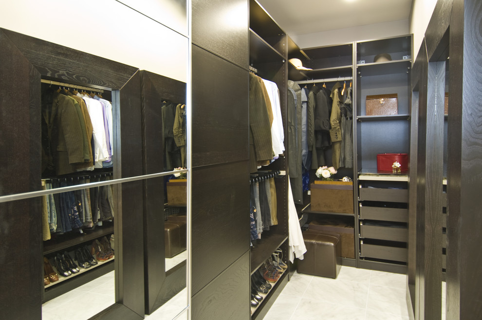 Transitional walk-in closet photo in San Francisco with dark wood cabinets