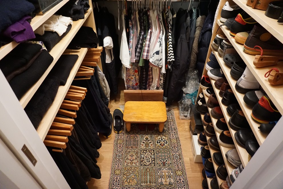Inspiration for a large modern gender neutral walk-in wardrobe in Toronto with open cabinets, light wood cabinets, light hardwood flooring and brown floors.