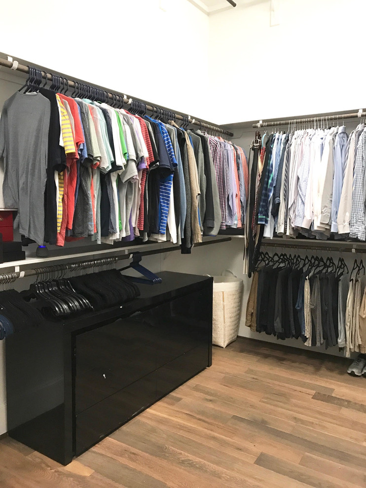 Design ideas for a medium sized classic walk-in wardrobe for men in Houston with open cabinets, cork flooring and brown floors.