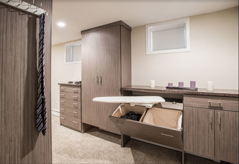 Design ideas for a contemporary wardrobe in Houston with flat-panel cabinets, brown cabinets, carpet and grey floors.
