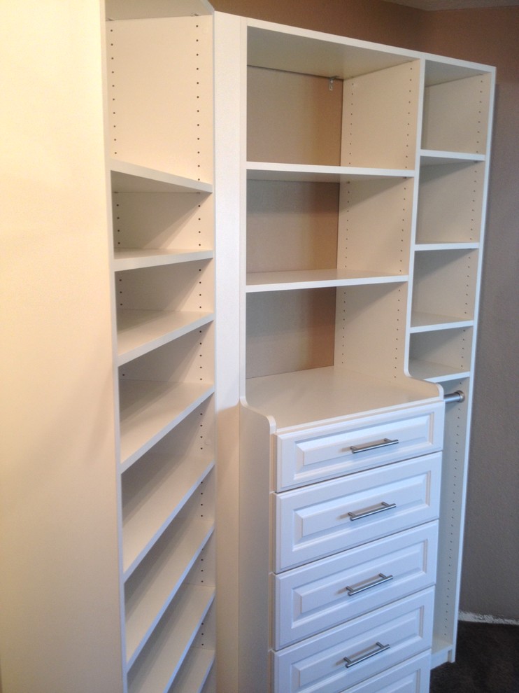 Photo of a medium sized classic gender neutral walk-in wardrobe in Orange County with raised-panel cabinets and white cabinets.