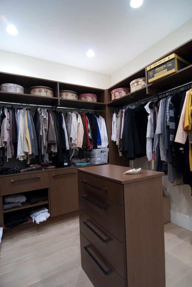 Large trendy gender-neutral walk-in closet photo in Grand Rapids with flat-panel cabinets and dark wood cabinets