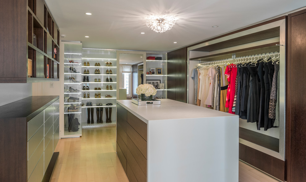 Design ideas for a contemporary dressing room in Boston with flat-panel cabinets, medium wood cabinets, light hardwood flooring, beige floors and feature lighting.