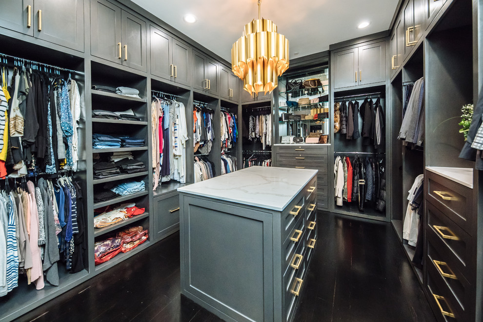 Large traditional gender neutral walk-in wardrobe in Dallas with grey cabinets, dark hardwood flooring, brown floors and shaker cabinets.
