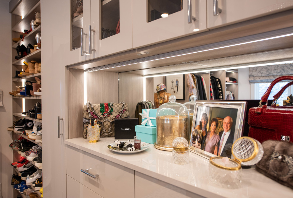 Inspiration for a large contemporary dressing room for women in Denver with flat-panel cabinets, grey cabinets, light hardwood flooring and brown floors.