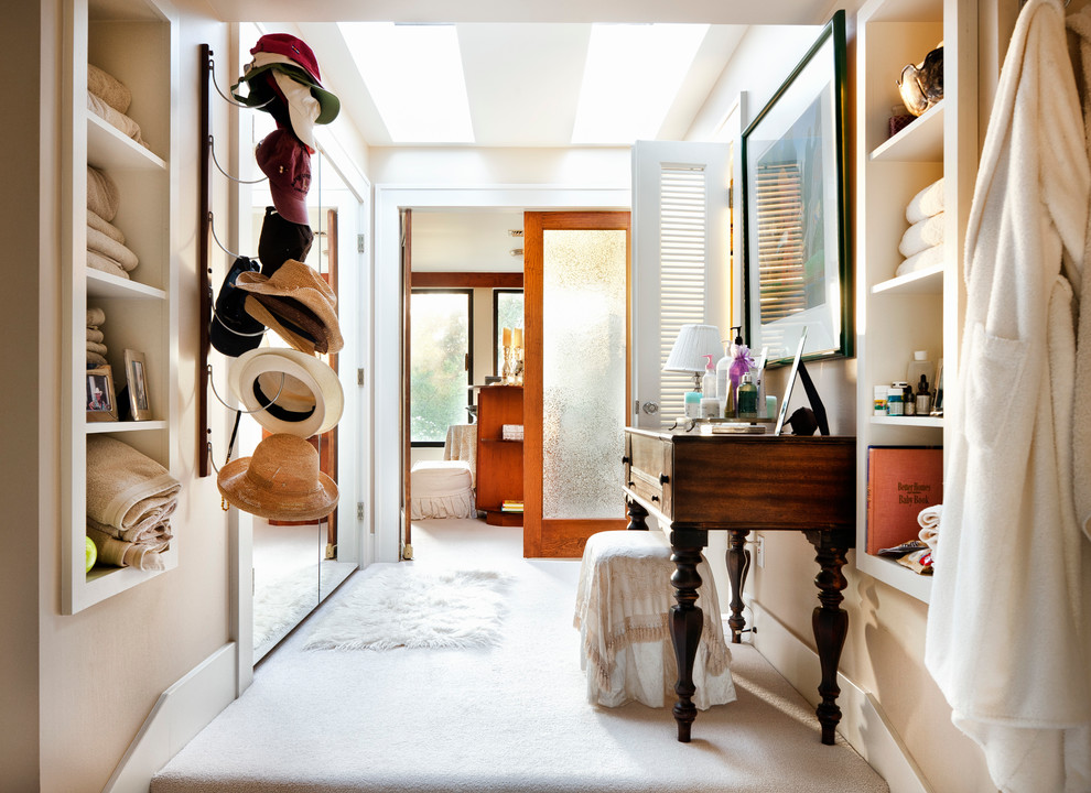 Inspiration for a traditional dressing room in Austin with open cabinets and beige cabinets.
