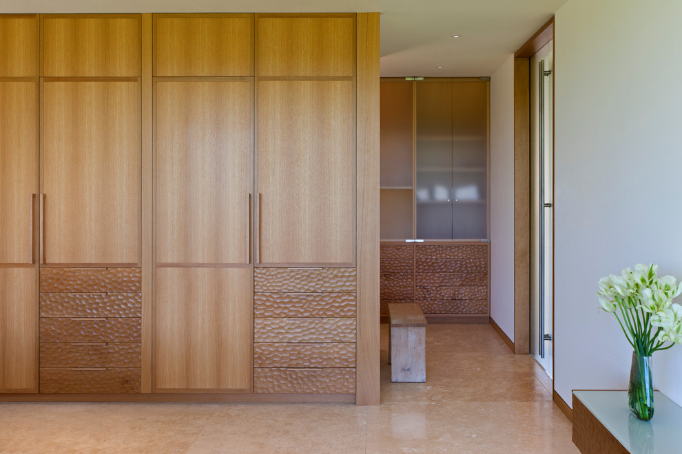 Contemporary wardrobe in Chicago with ceramic flooring and medium wood cabinets.