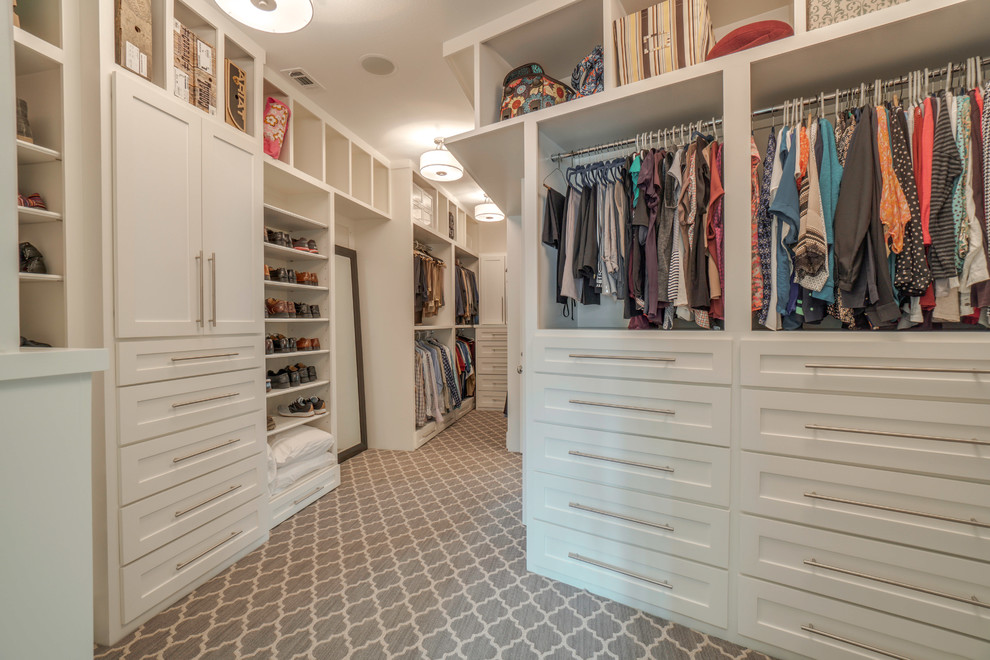 Design ideas for a large classic gender neutral walk-in wardrobe in Houston with shaker cabinets, white cabinets, carpet and grey floors.