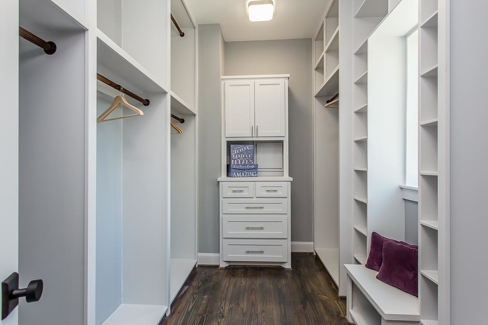 Walk-in closet - mid-sized craftsman gender-neutral dark wood floor and brown floor walk-in closet idea in Houston with open cabinets and white cabinets