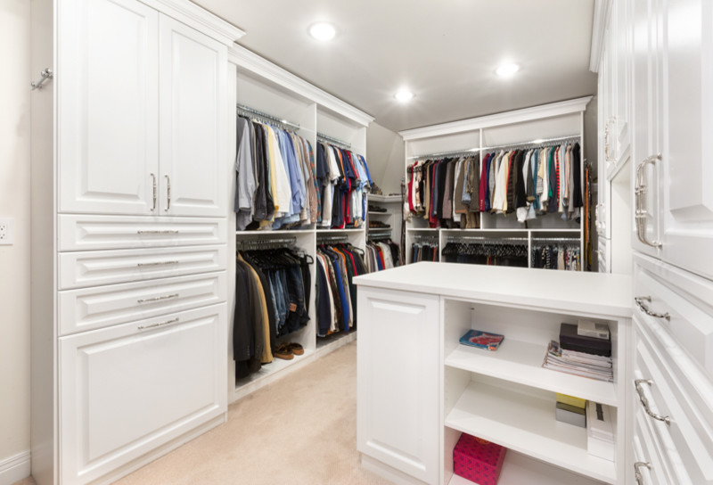 Inspiration for a large classic gender neutral walk-in wardrobe in Chicago with raised-panel cabinets, white cabinets and carpet.