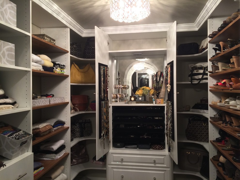 Foto de armario vestidor unisex vintage de tamaño medio con armarios con paneles con relieve, puertas de armario blancas y suelo de madera en tonos medios