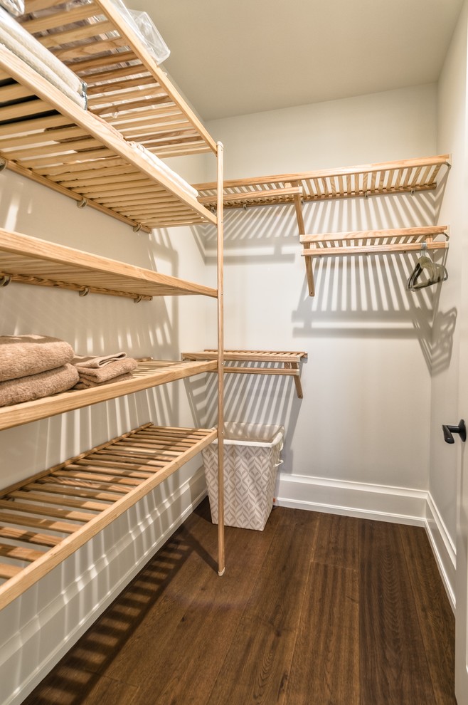 Inspiration for a mid-sized coastal gender-neutral medium tone wood floor walk-in closet remodel in Miami with light wood cabinets