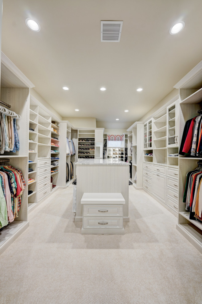 Inspiration for a large transitional gender-neutral carpeted and beige floor dressing room remodel in Oklahoma City with raised-panel cabinets and light wood cabinets