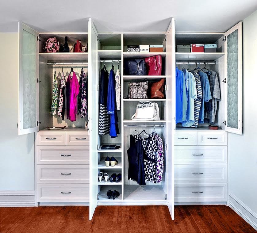 Reach-in closet - transitional gender-neutral medium tone wood floor reach-in closet idea in Philadelphia with recessed-panel cabinets and white cabinets