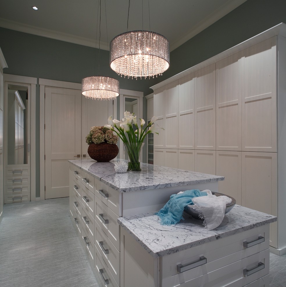 Large traditional walk-in wardrobe for women in Tampa with recessed-panel cabinets, white cabinets, grey floors and carpet.