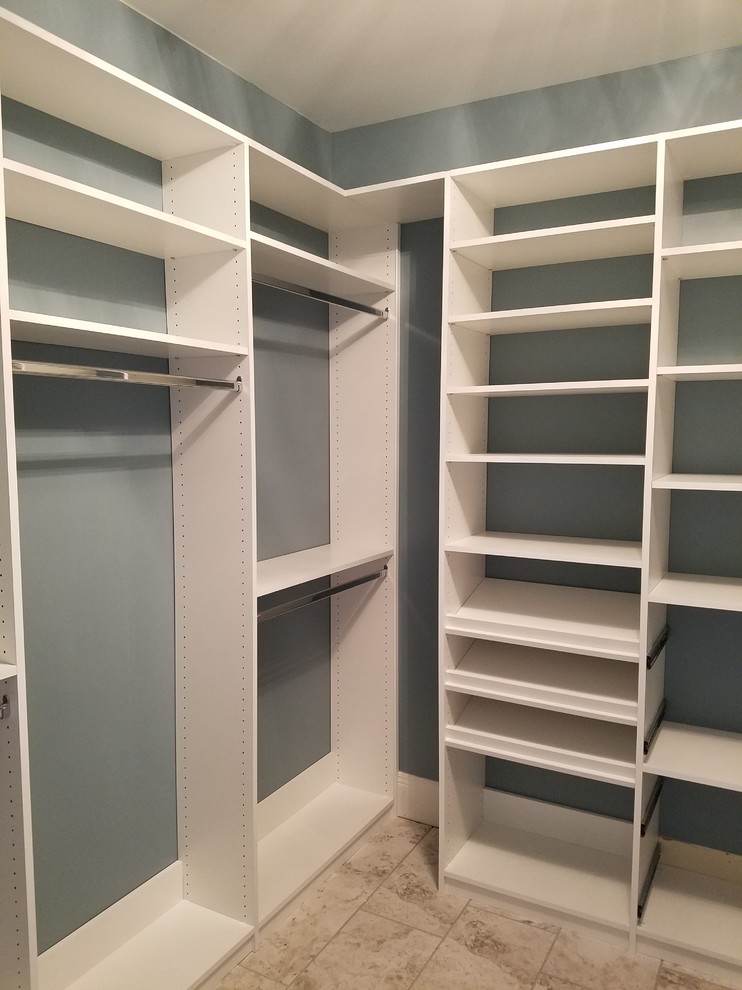 Photo of a medium sized traditional gender neutral walk-in wardrobe in Louisville with open cabinets, white cabinets, porcelain flooring and brown floors.