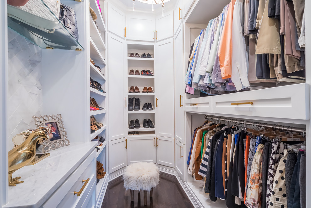 Example of a transitional gender-neutral dark wood floor and brown floor walk-in closet design in Houston with open cabinets and white cabinets
