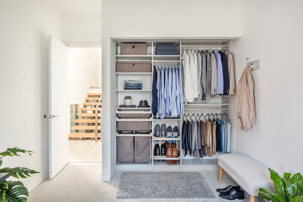 Small modern gender neutral standard wardrobe in New York with carpet, grey floors, open cabinets and white cabinets.