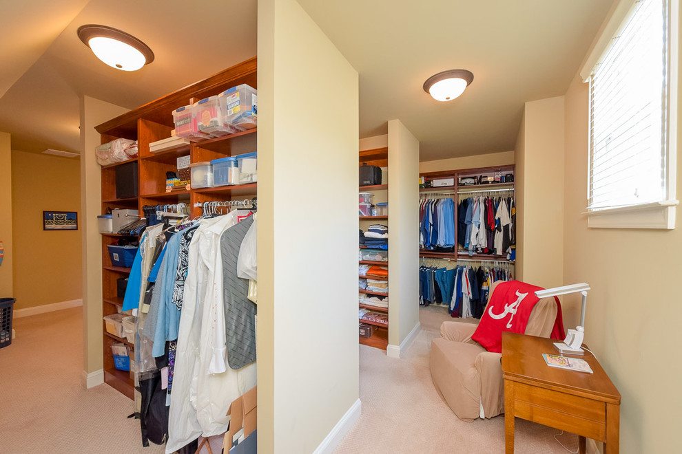 Inspiration for a huge craftsman gender-neutral carpeted walk-in closet remodel in Atlanta with open cabinets and medium tone wood cabinets