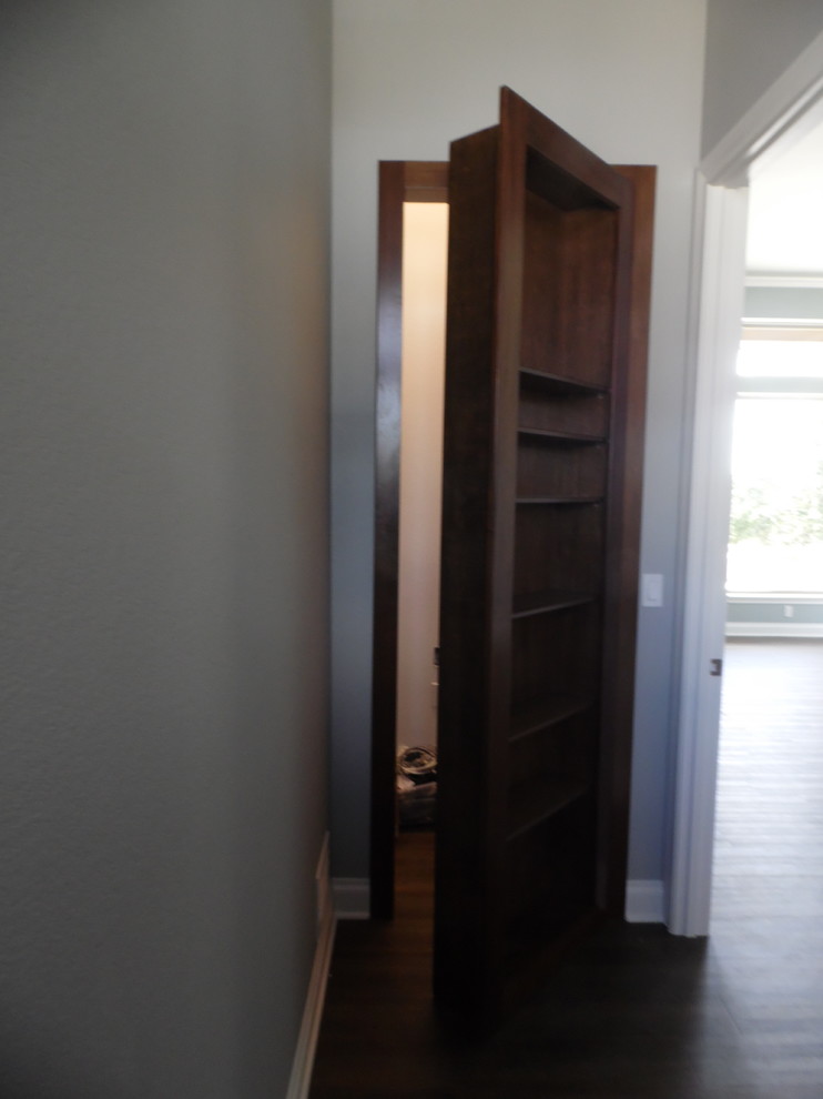 Medium sized traditional gender neutral walk-in wardrobe in Austin with dark hardwood flooring.