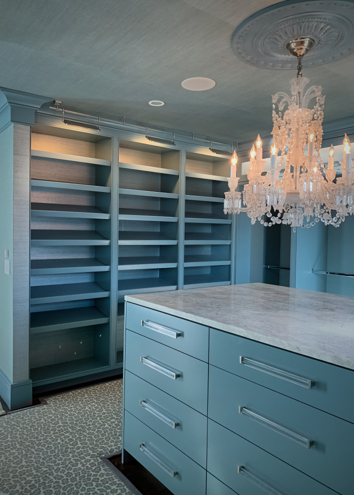 Inspiration for a medium sized walk-in wardrobe in Bridgeport with flat-panel cabinets, blue cabinets, carpet and a wallpapered ceiling.