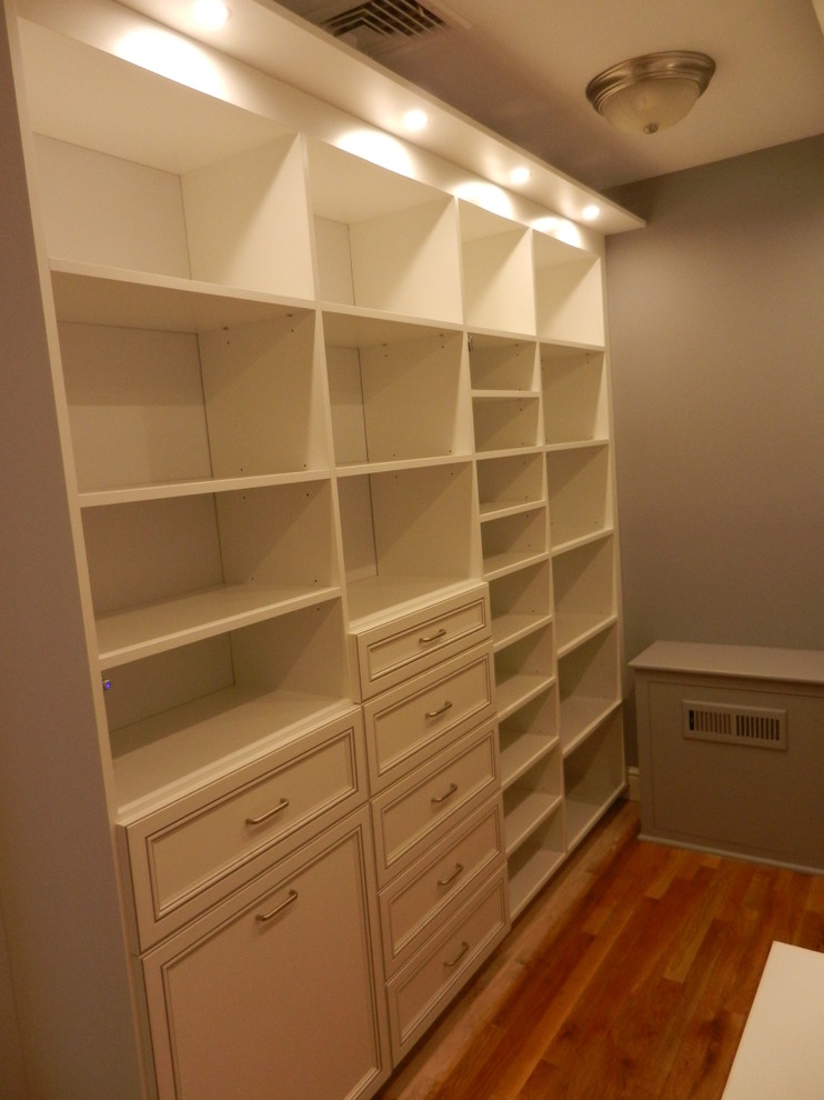 Inspiration for a large timeless gender-neutral walk-in closet remodel in Other