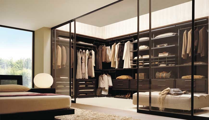 Walk-in closet - large contemporary gender-neutral carpeted walk-in closet idea in Dallas with dark wood cabinets