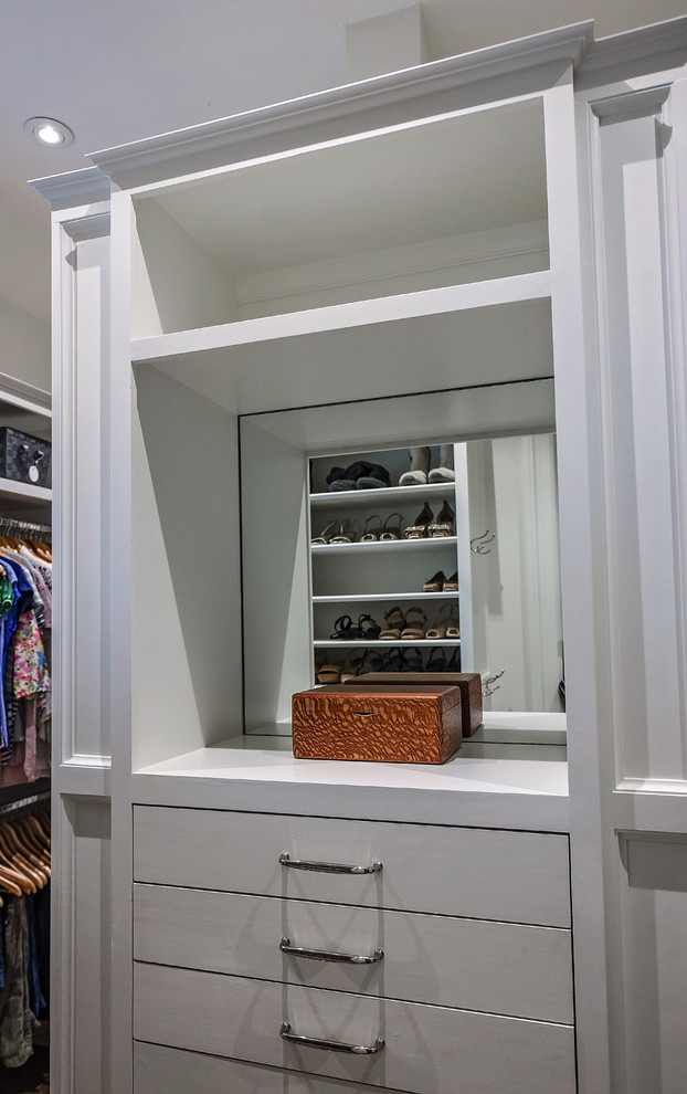 Large traditional gender neutral dressing room in Jacksonville with flat-panel cabinets, white cabinets and medium hardwood flooring.