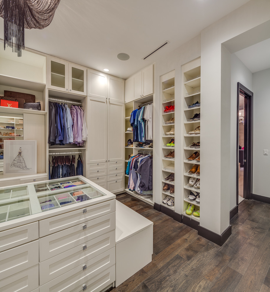 Example of a large trendy men's medium tone wood floor walk-in closet design in Jacksonville with recessed-panel cabinets and white cabinets