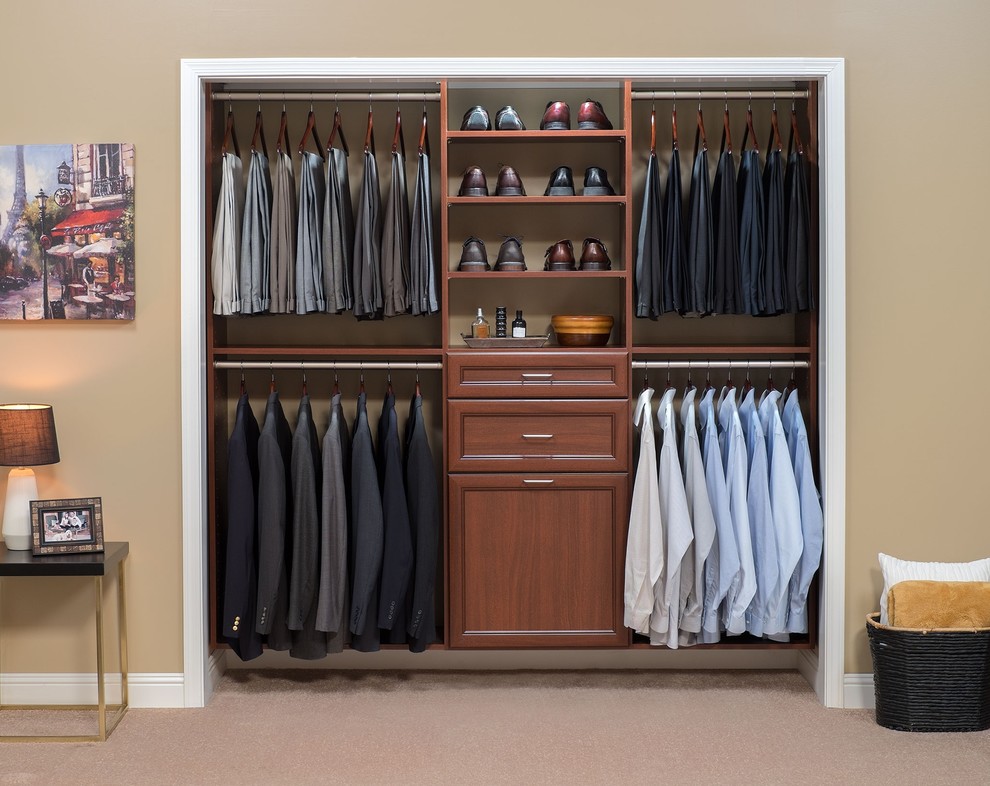 This is an example of a small traditional standard wardrobe for men in Denver with carpet, recessed-panel cabinets and medium wood cabinets.