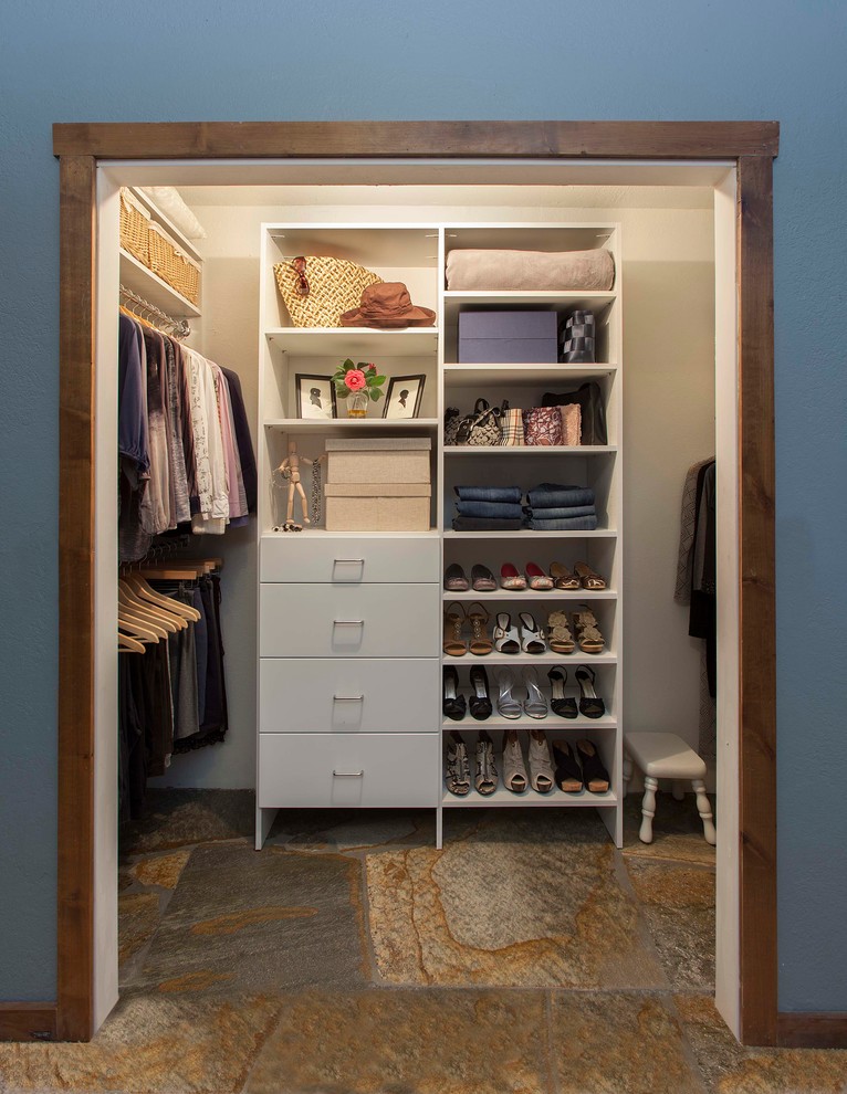 This is an example of a medium sized traditional standard wardrobe for women in Denver with flat-panel cabinets, white cabinets and slate flooring.