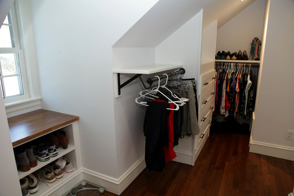 This is an example of a medium sized classic gender neutral walk-in wardrobe in Boston with recessed-panel cabinets, dark hardwood flooring and brown floors.