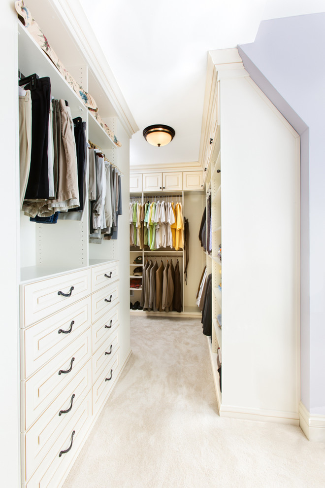 Photo of a large traditional walk-in wardrobe in Chicago with raised-panel cabinets, white cabinets and carpet.