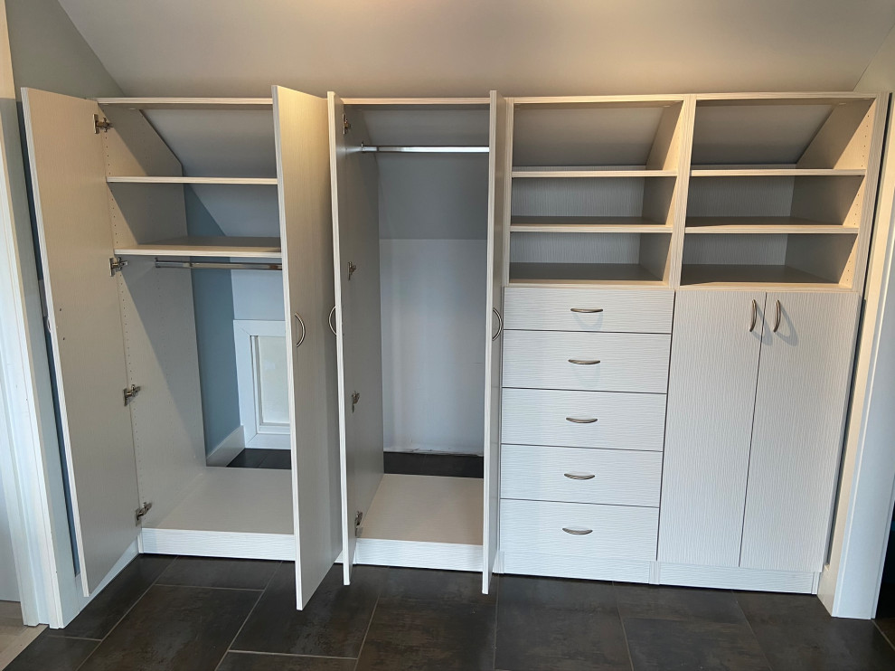 Brown floor closet photo in Minneapolis with flat-panel cabinets and white cabinets
