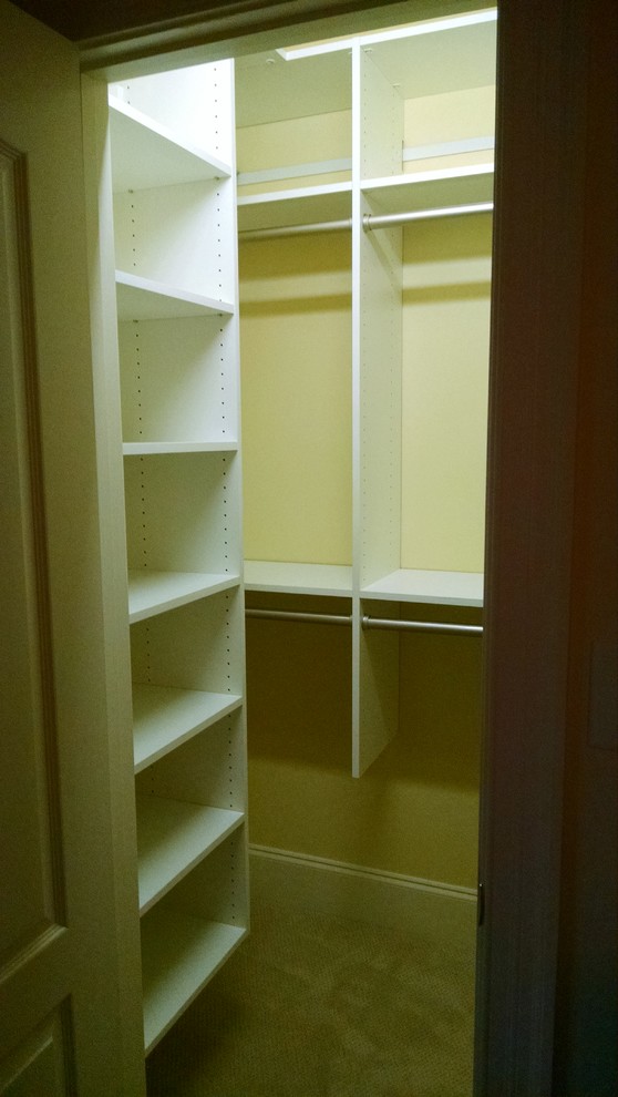 Design ideas for a small walk-in wardrobe for women in Other with white cabinets.