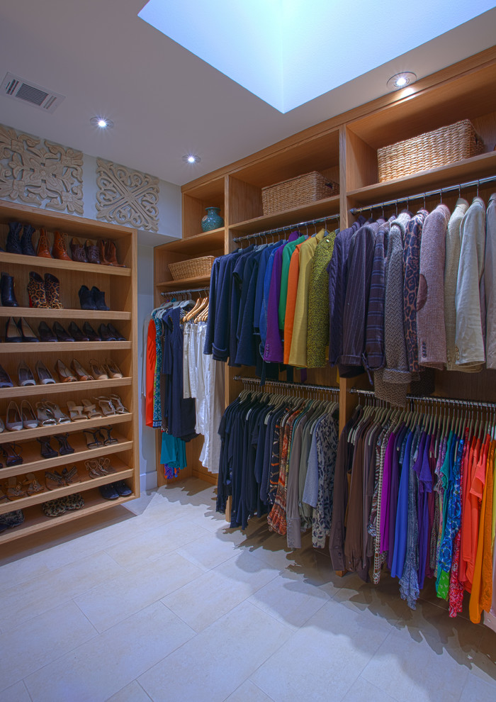 Design ideas for a medium sized contemporary gender neutral walk-in wardrobe in Dallas with flat-panel cabinets, light wood cabinets and ceramic flooring.