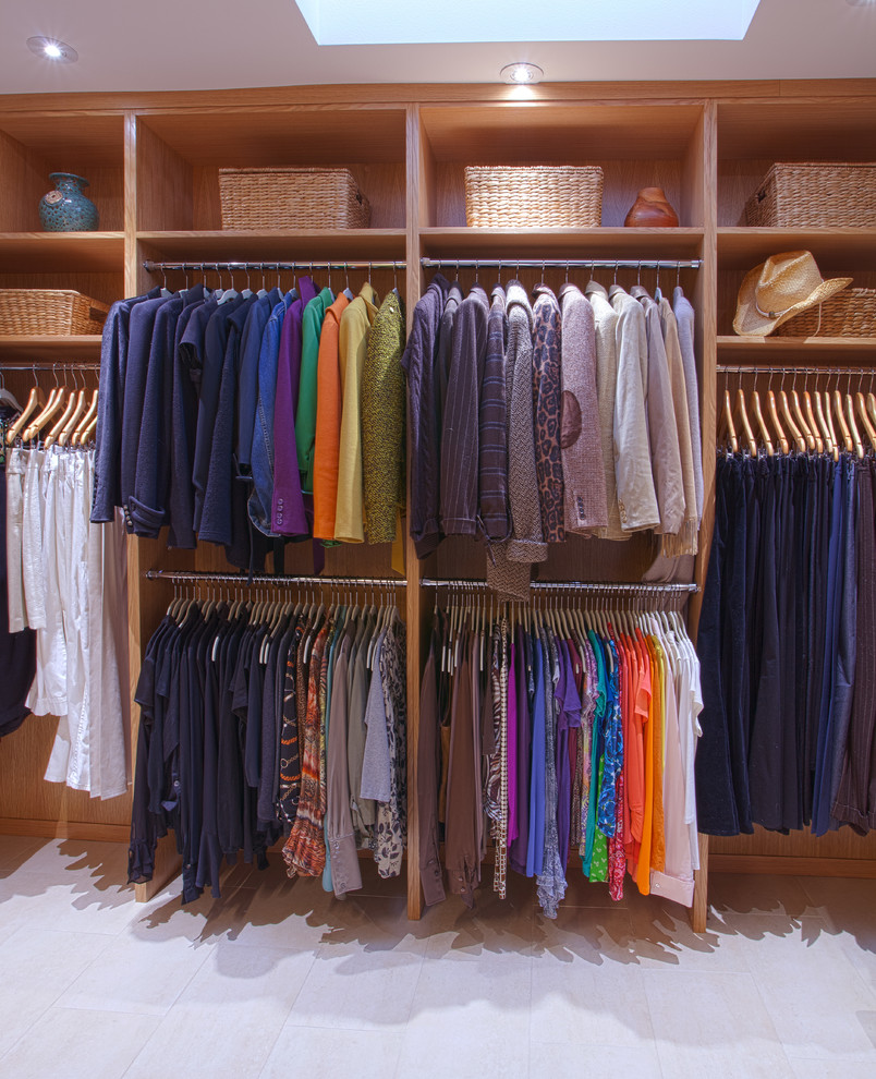 Inspiration for a medium sized contemporary gender neutral walk-in wardrobe in Dallas with flat-panel cabinets, light wood cabinets and ceramic flooring.