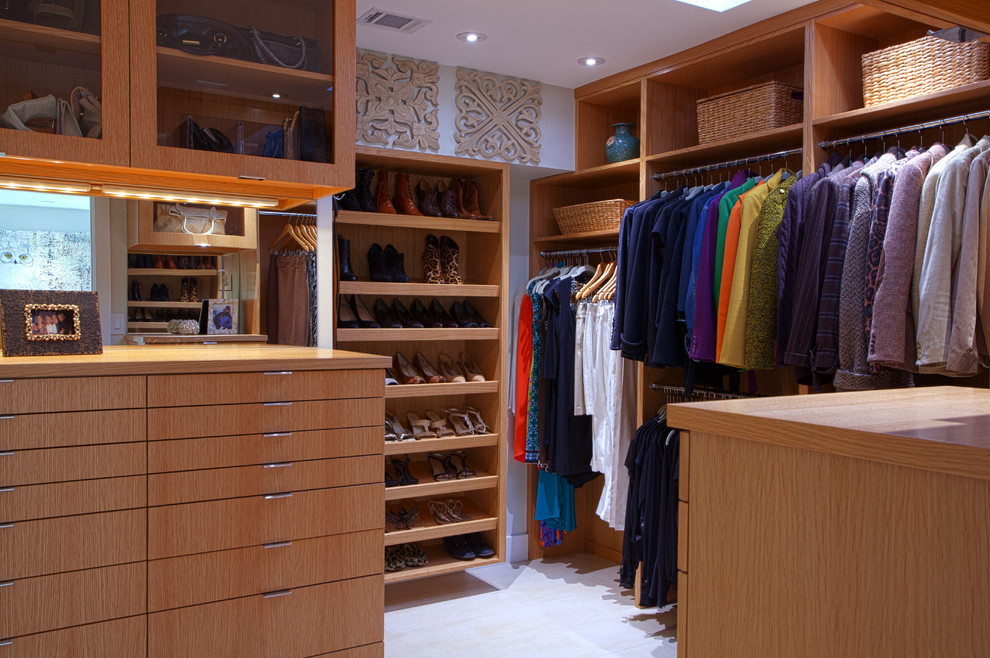 Large contemporary gender neutral walk-in wardrobe in Dallas with flat-panel cabinets, light wood cabinets and ceramic flooring.